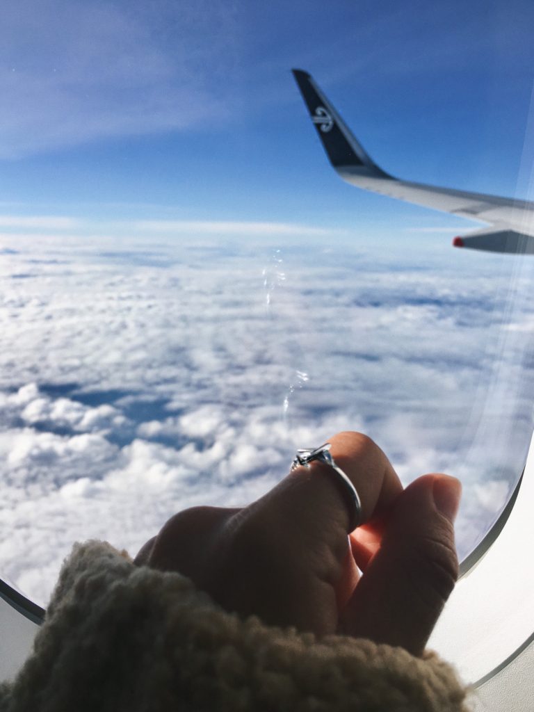 new zealand slang: air new zealand airplane wing over the clouds; niki wears an airplane ring