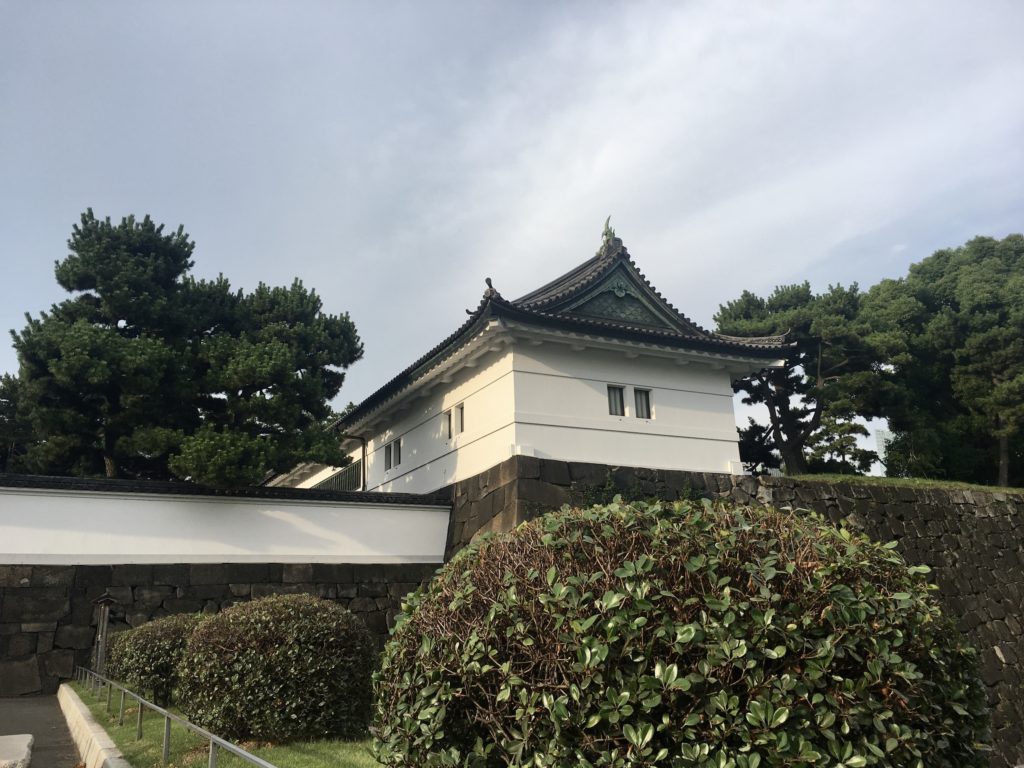 what to do in tokyo: white building surrounded by hedges and trees