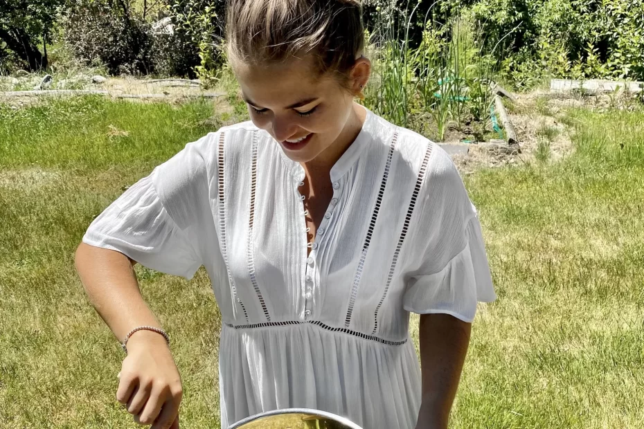 niki stirs a pot of elderflower cordial