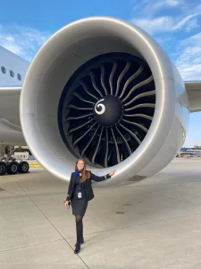 niki stands in front of a large airplane engine