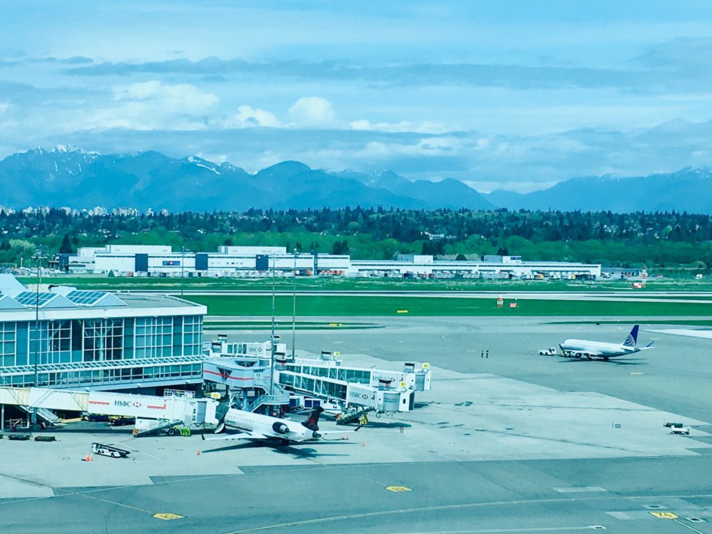 airport tarmac and mountains in the background