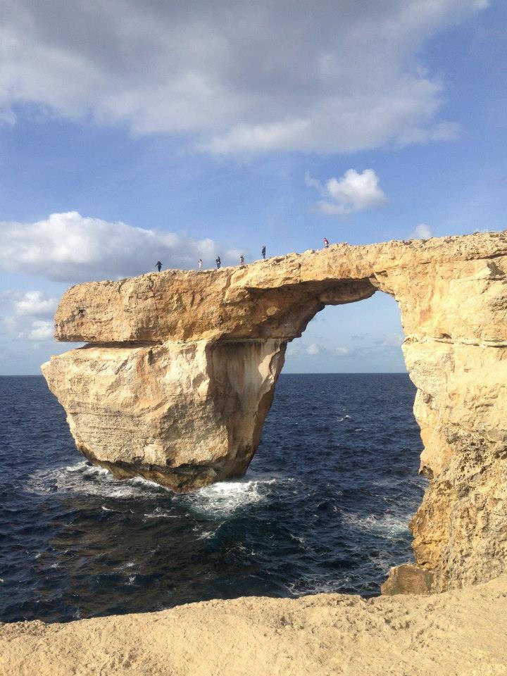 reasons to study abroad: niki sits on edge of cliff in malta