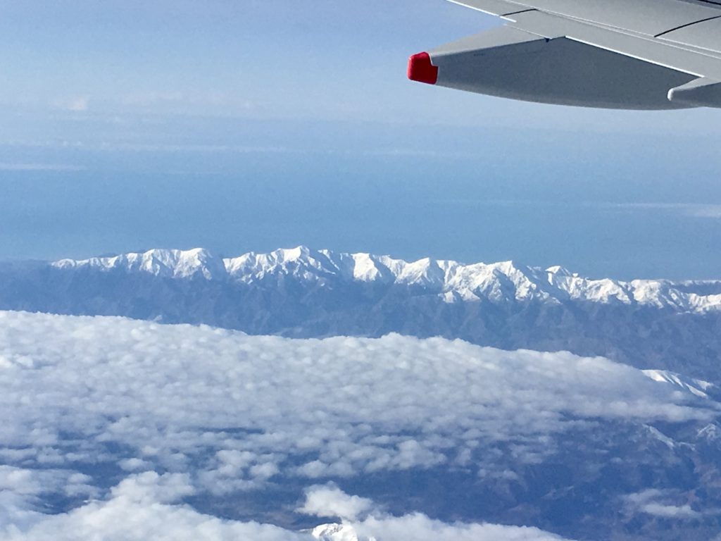 flight attendant faq: airplane wing with mountains below