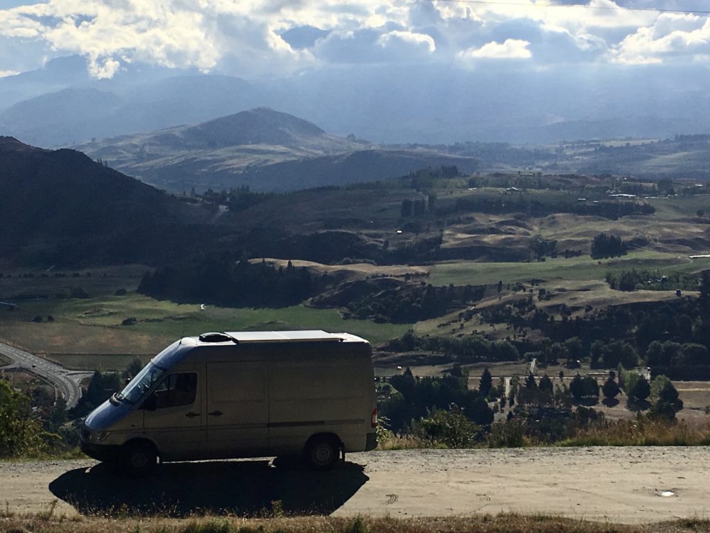 the van with sweeping views of new zealand in the background