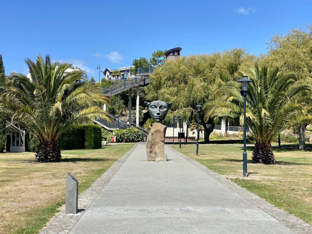 Sculpture with a face on it and some palm trees, Caroline Bay, Timaru, New Zealand