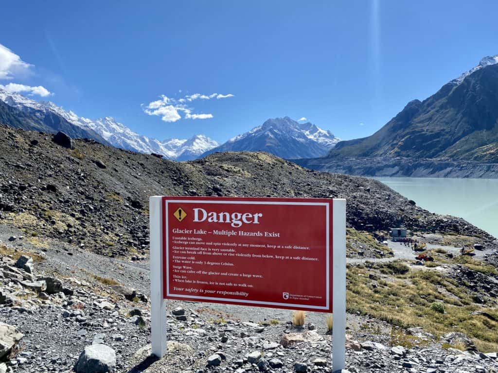 danger sign in front of the lake