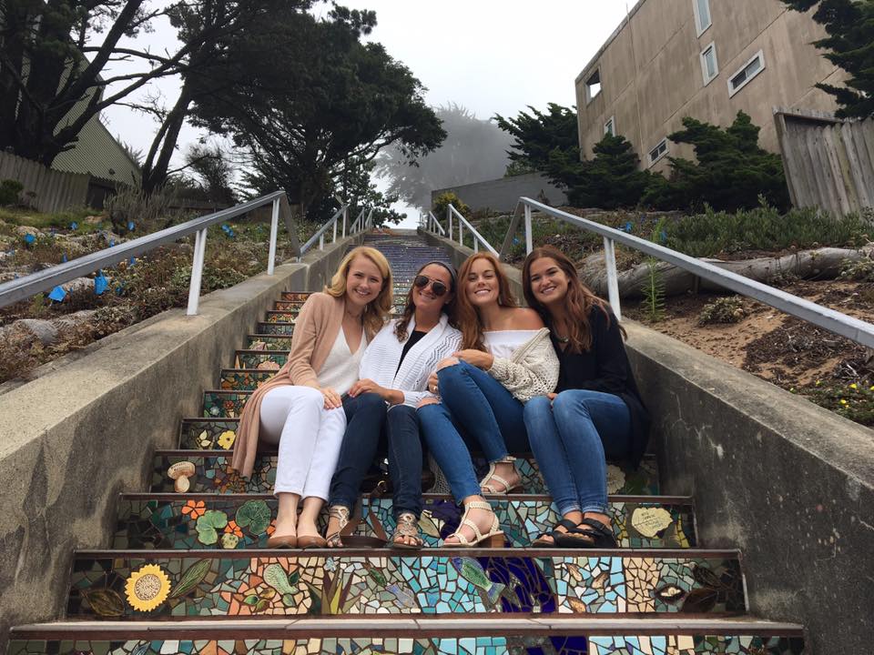 San Francisco travel guide: Niki and three friends sit on the 16th Avenue Tiled Steps in San Francisco, California