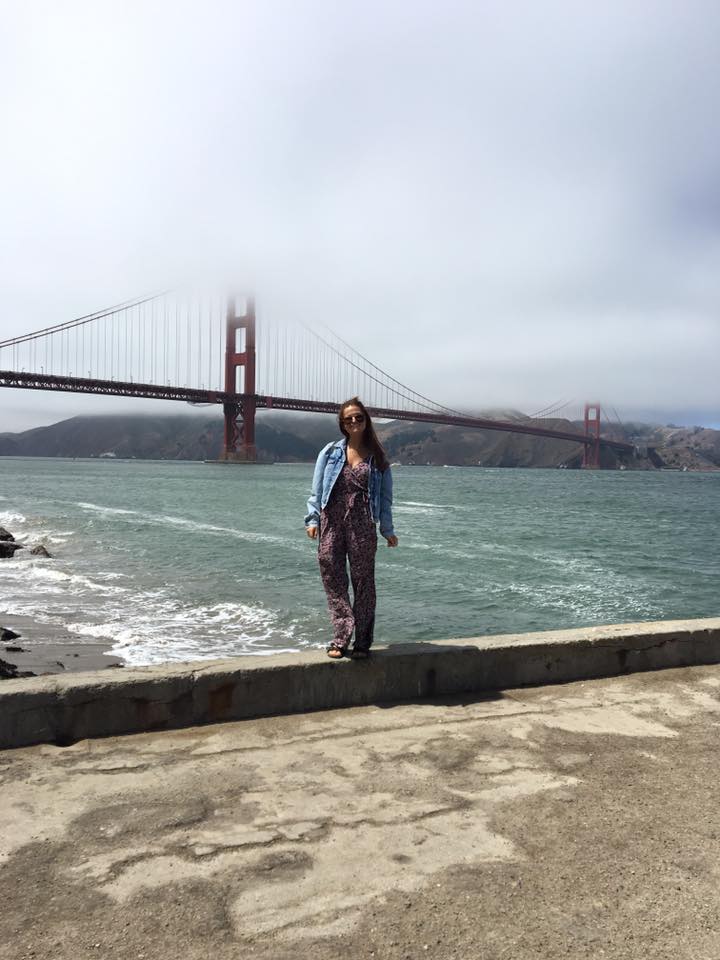 San Francisco travel guide: Niki stands in front of the Golden Gate Bridge, San Francisco California