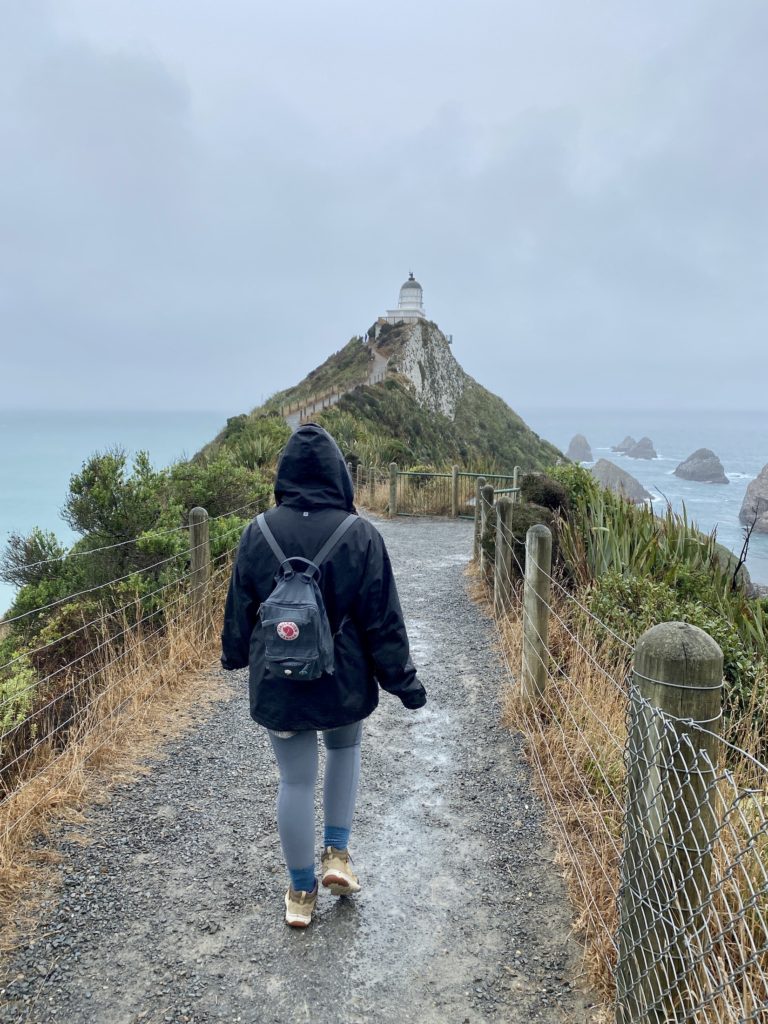 Niki walks along the trail to Nugget Point Lighthouse