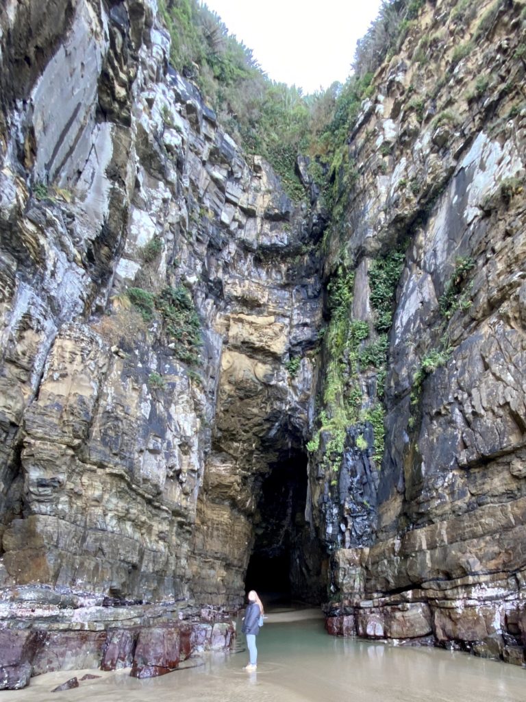 Niki stands in front of the Cathedral Caves entrance