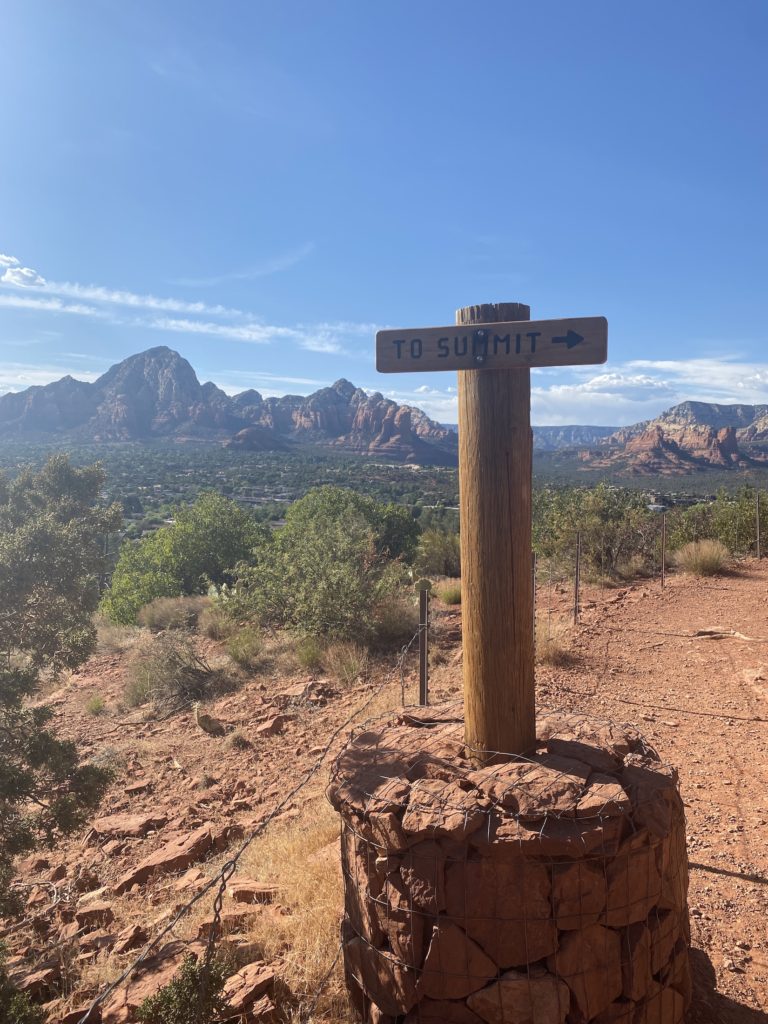 Sedona itinerary: Airport Mesa summit sign and views of Sedona in the background