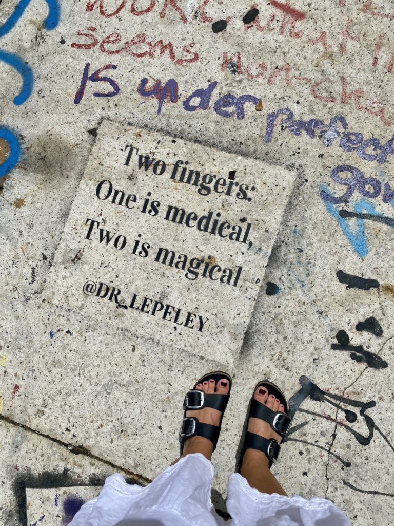 Street art on the ground in Miami: "Two fingers: One is medical, two is magical"