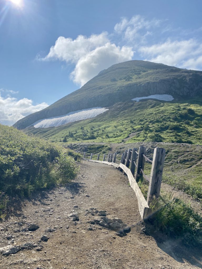 Path leading to Flattop Mountain with snow on the side