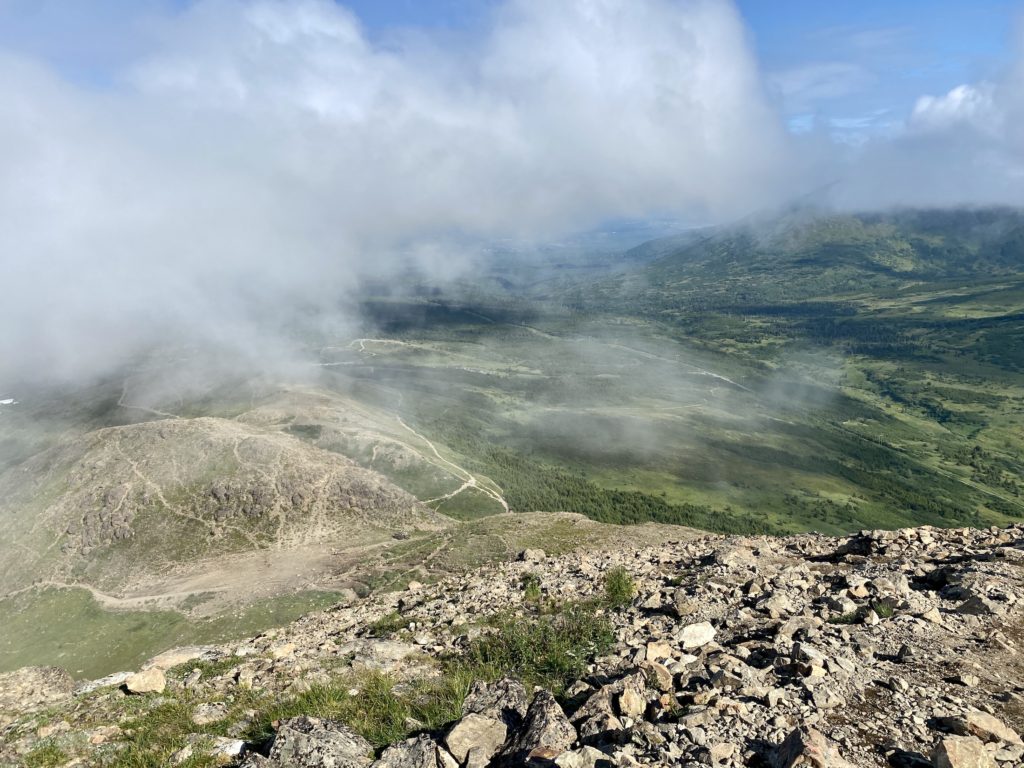 Clouds and sprawling views from the top of Flattop Mountain