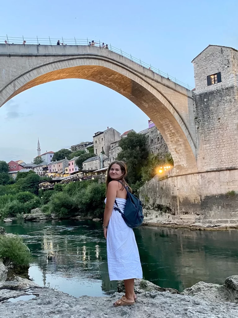 Niki stands in front of Stari Most (Old Bridge) in Mostar, Bosnia & Herzegovina