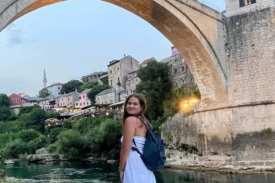 Niki stands in front of Stari Most (Old Bridge) in Mostar, Bosnia & Herzegovina