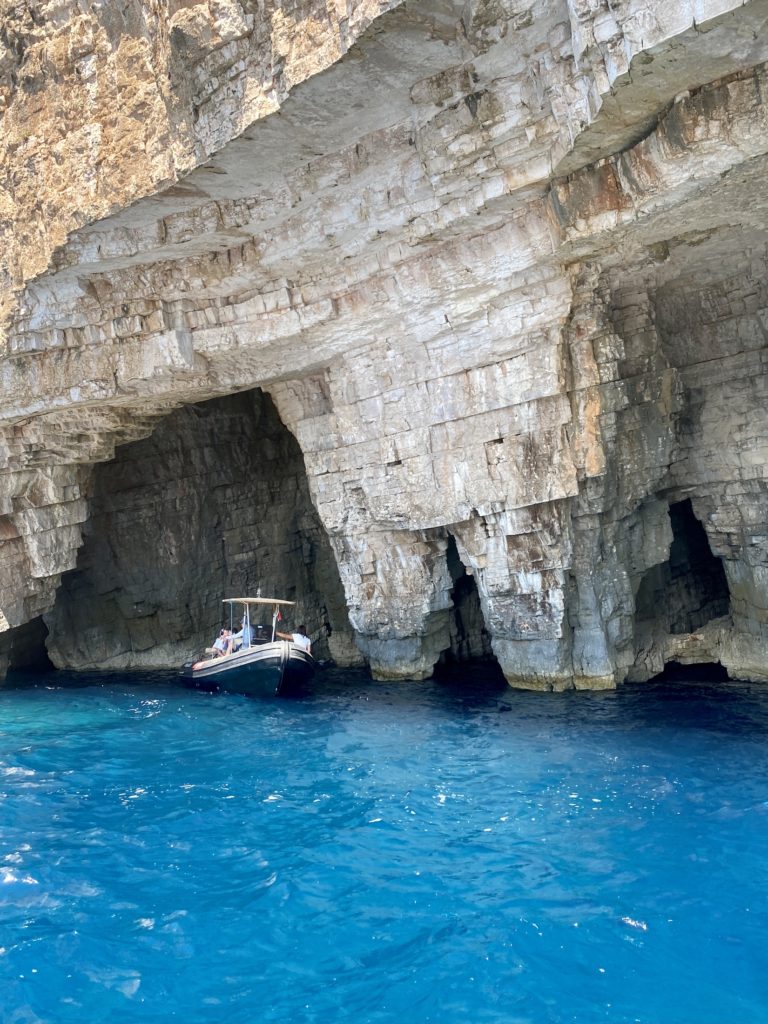 Croatia island hopping: Boat and cave formations in Vis, Croatia