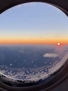 How to travel more: View of sunset out of an airplane window