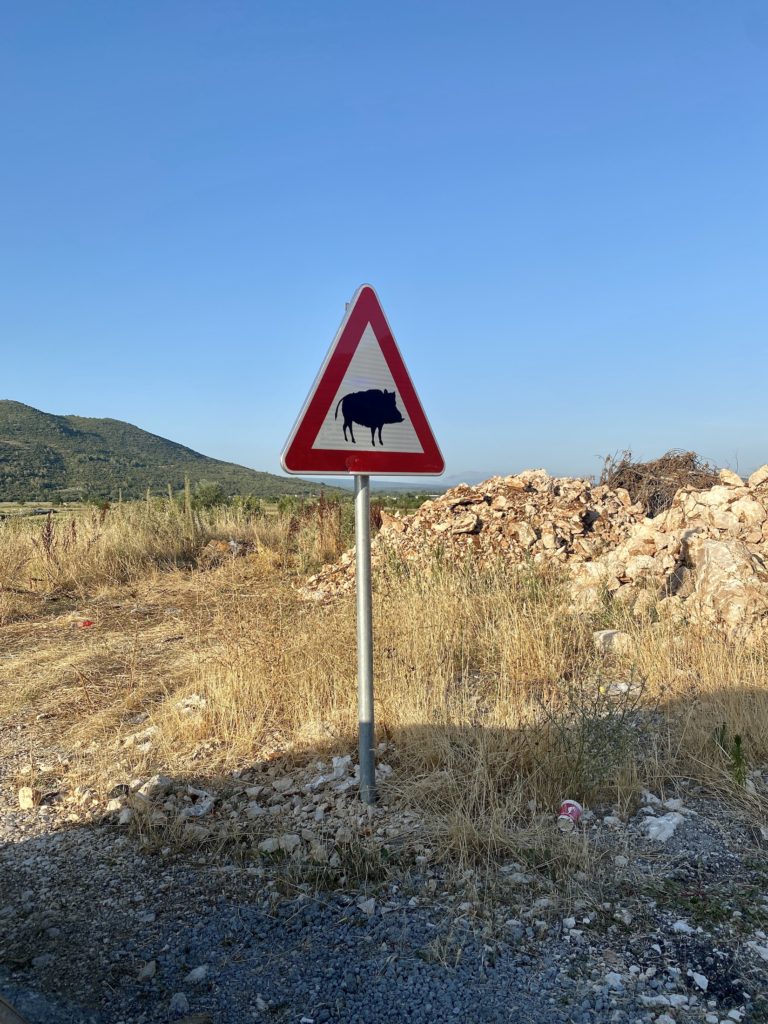 Triangular sign with a pig, Bosnian countryside