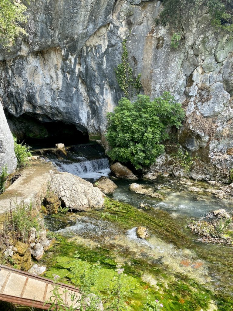 Natural water source next to a cave in the Bosnian countryside