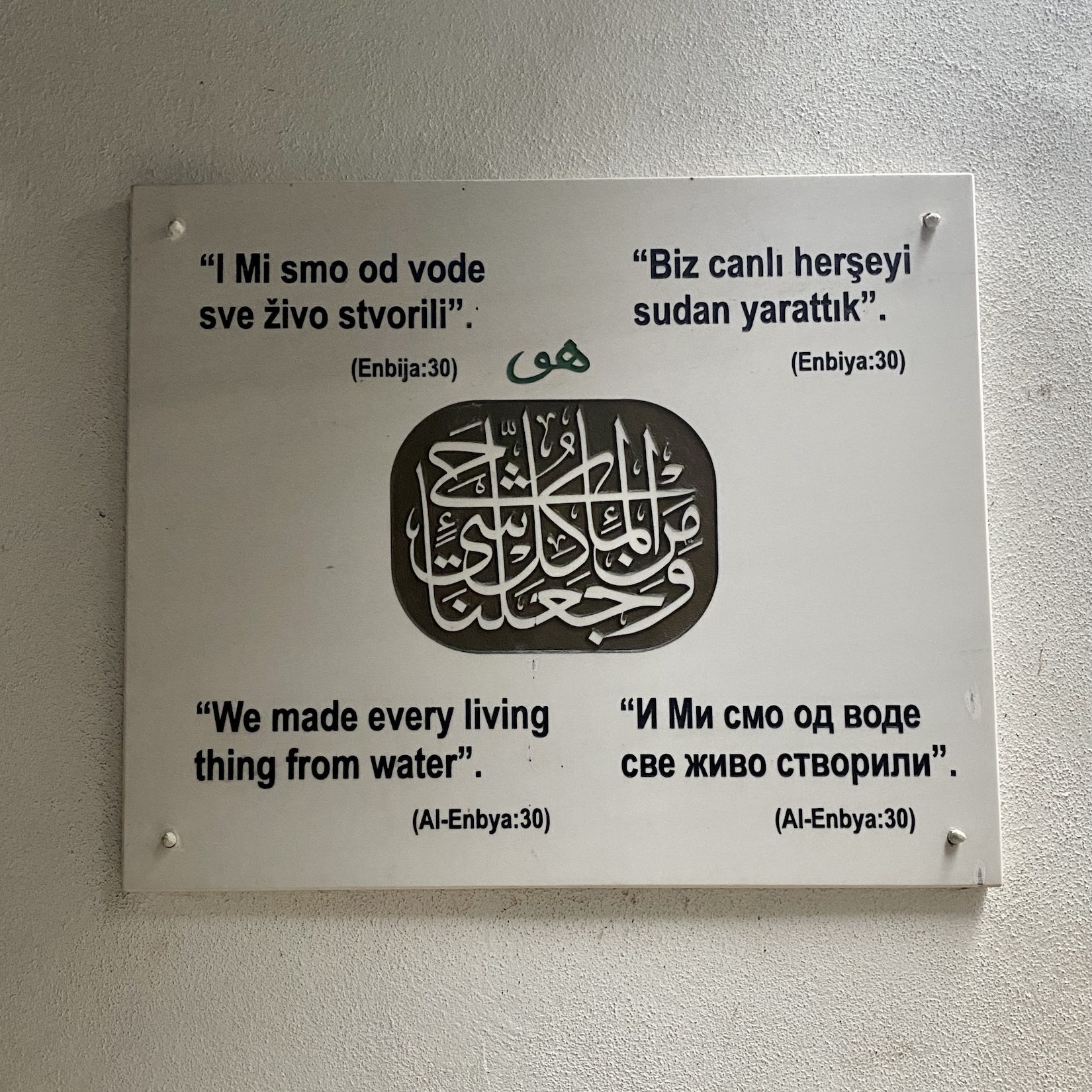 Sign at Dervish House Monastery, Bosnia & Herzegovina that says "We made every living thing from water" in 4 languages