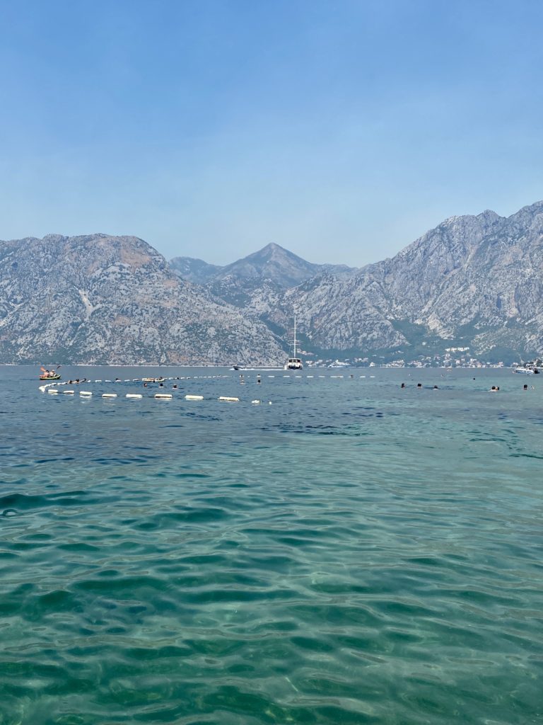 Kotor travel guide: Bright blue water and mountains in the bay of Kotor, Montenegro