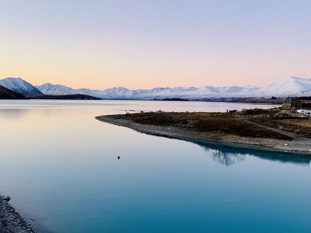 South Island New Zealand road trip: View of mountains and Church of the Good Shepard at sunset, Lake Tekapo, New Zealand