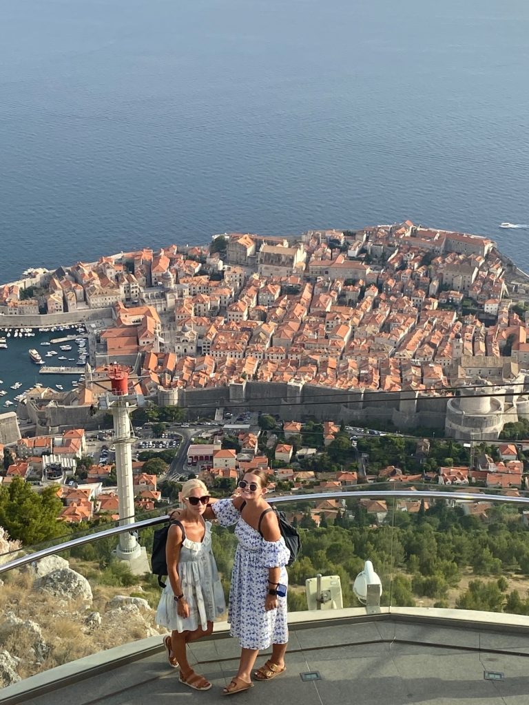 Niki and Lucy stand in front of view of Old Town Dubrovnik, Croatia