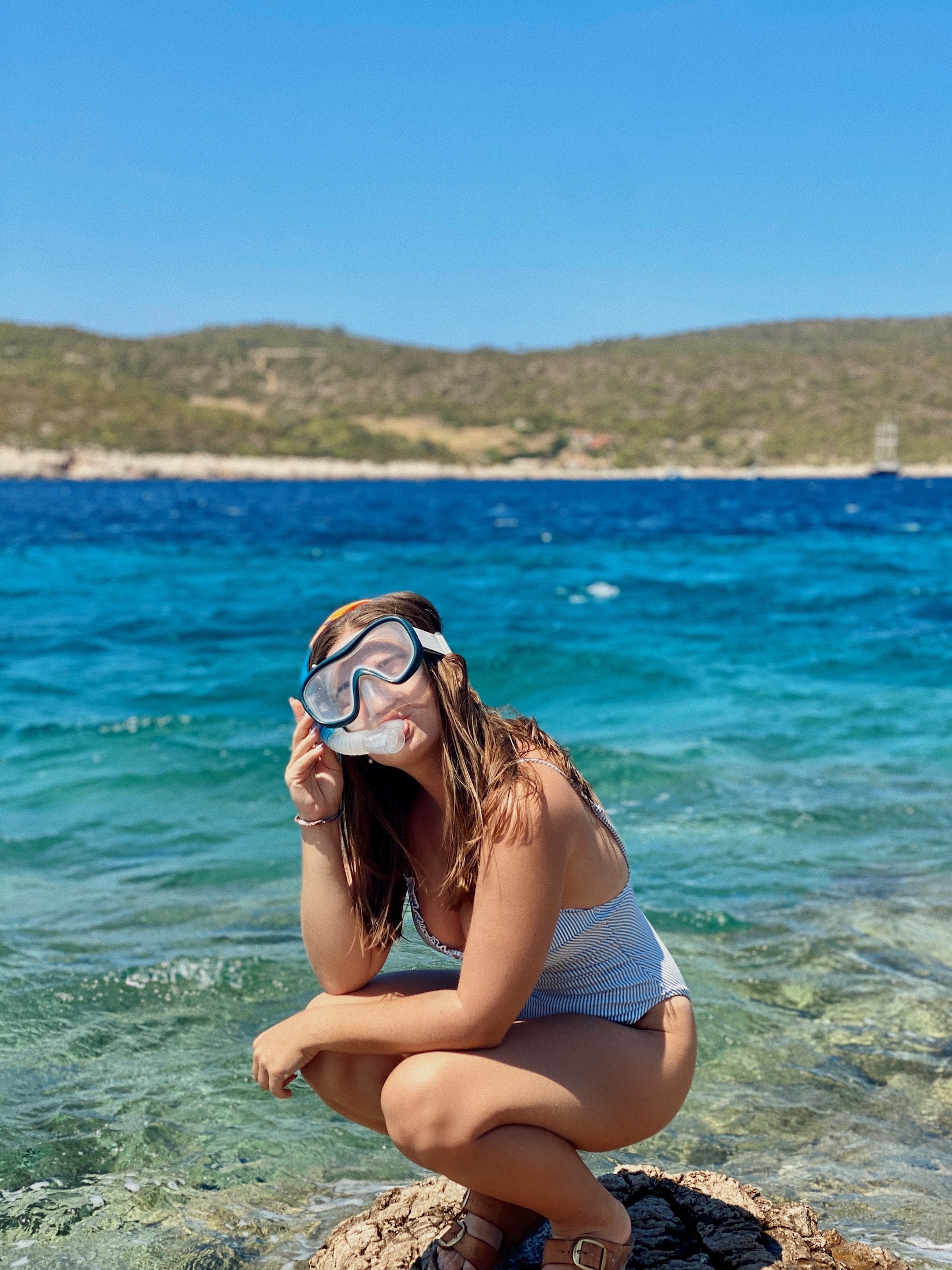 niki in front of blue water on vis island, croatia