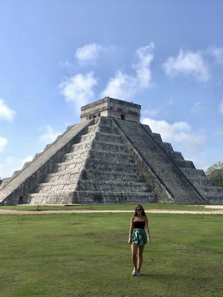 How to travel more: Niki stands in front of Chichen Itza, one of the Seven Wonders of the World in Mexico