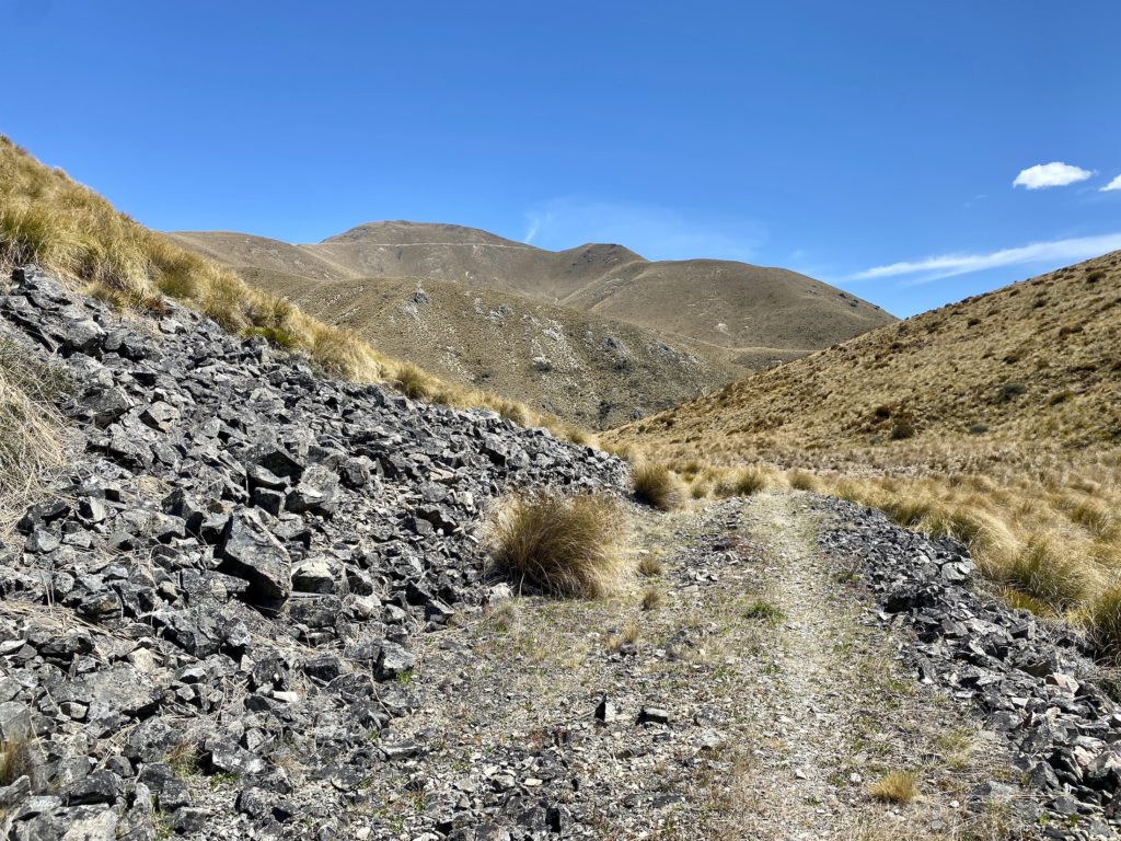 Rocky trail through mountain valleys on the Greta Track