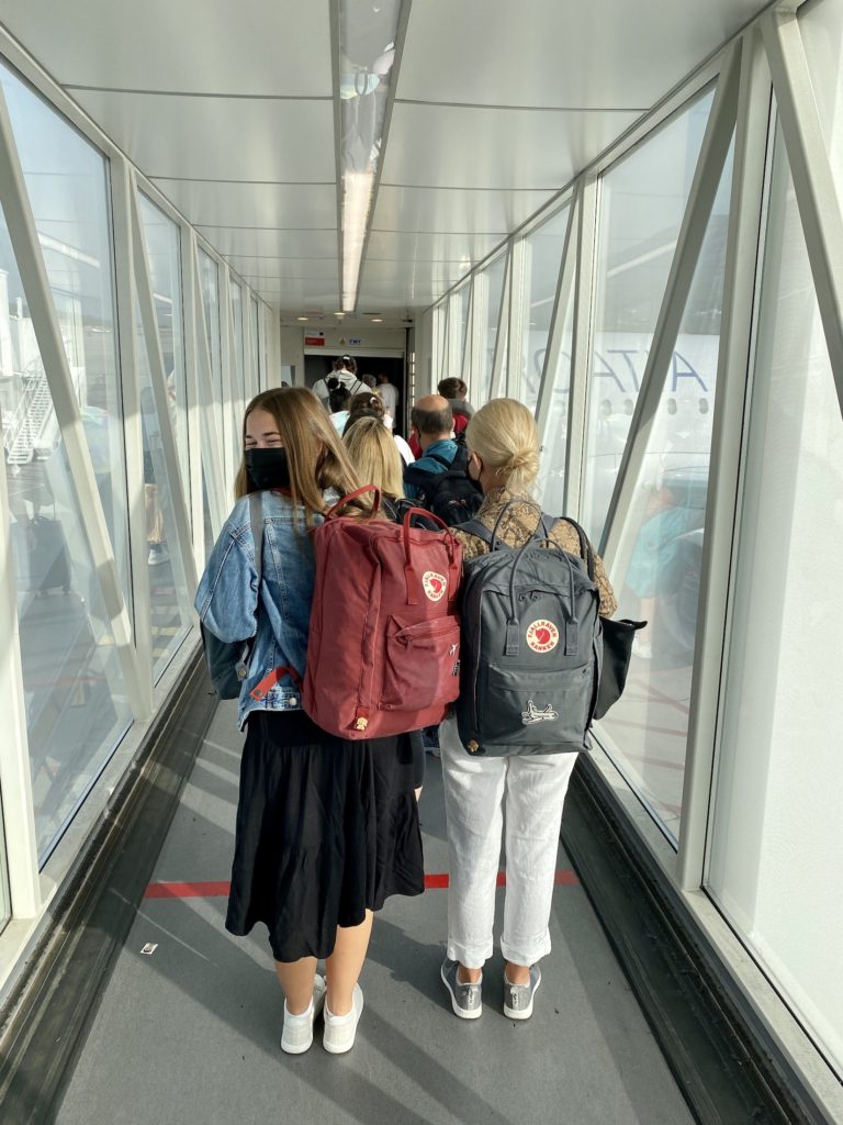 One Second Everyday in 2021: Niki stands on a jetbridge waiting to get on an airplane
