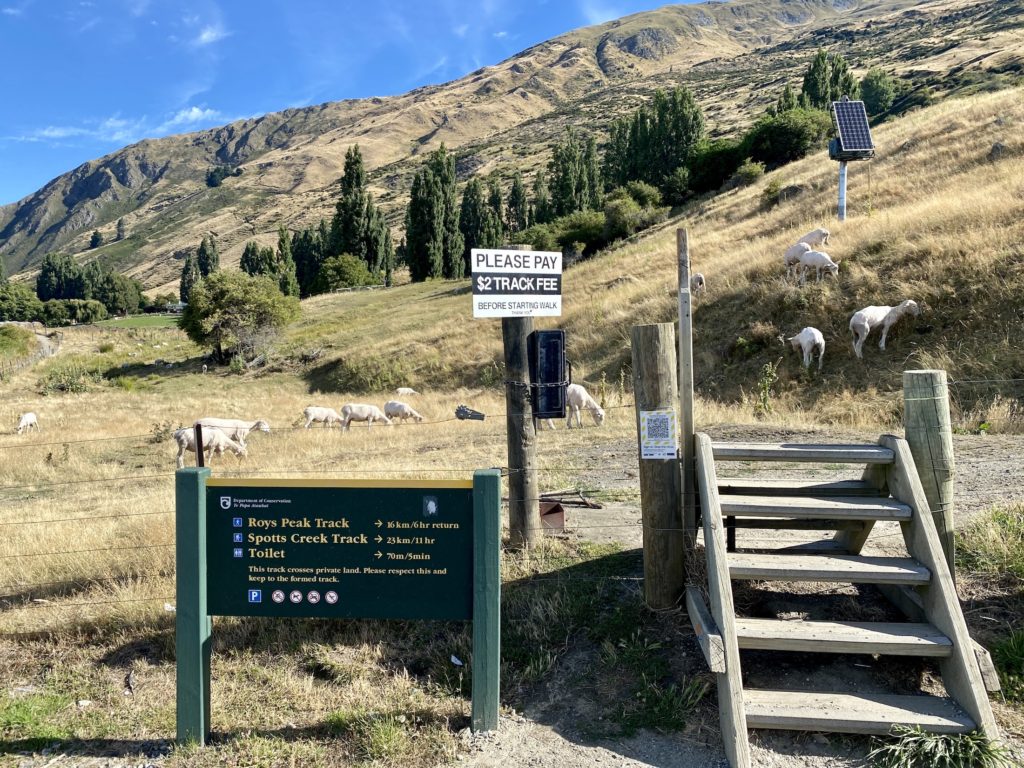 First stile and sign at Roys Peak trailhead, Wanaka, New Zealand