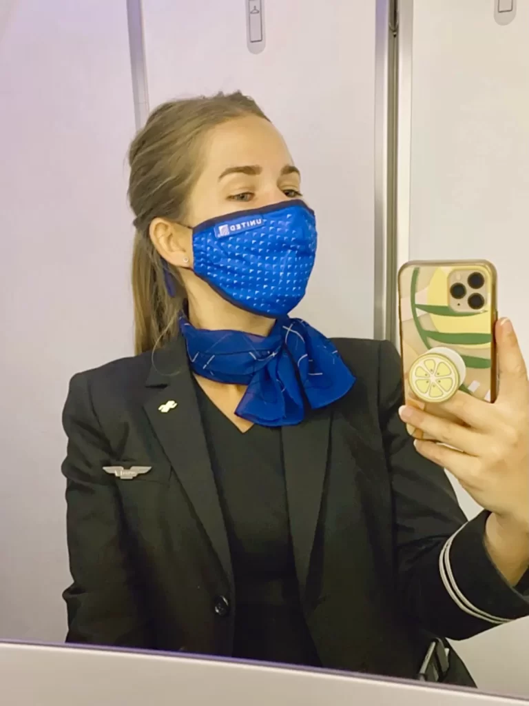 Niki takes a selfie in an airplane lavatory