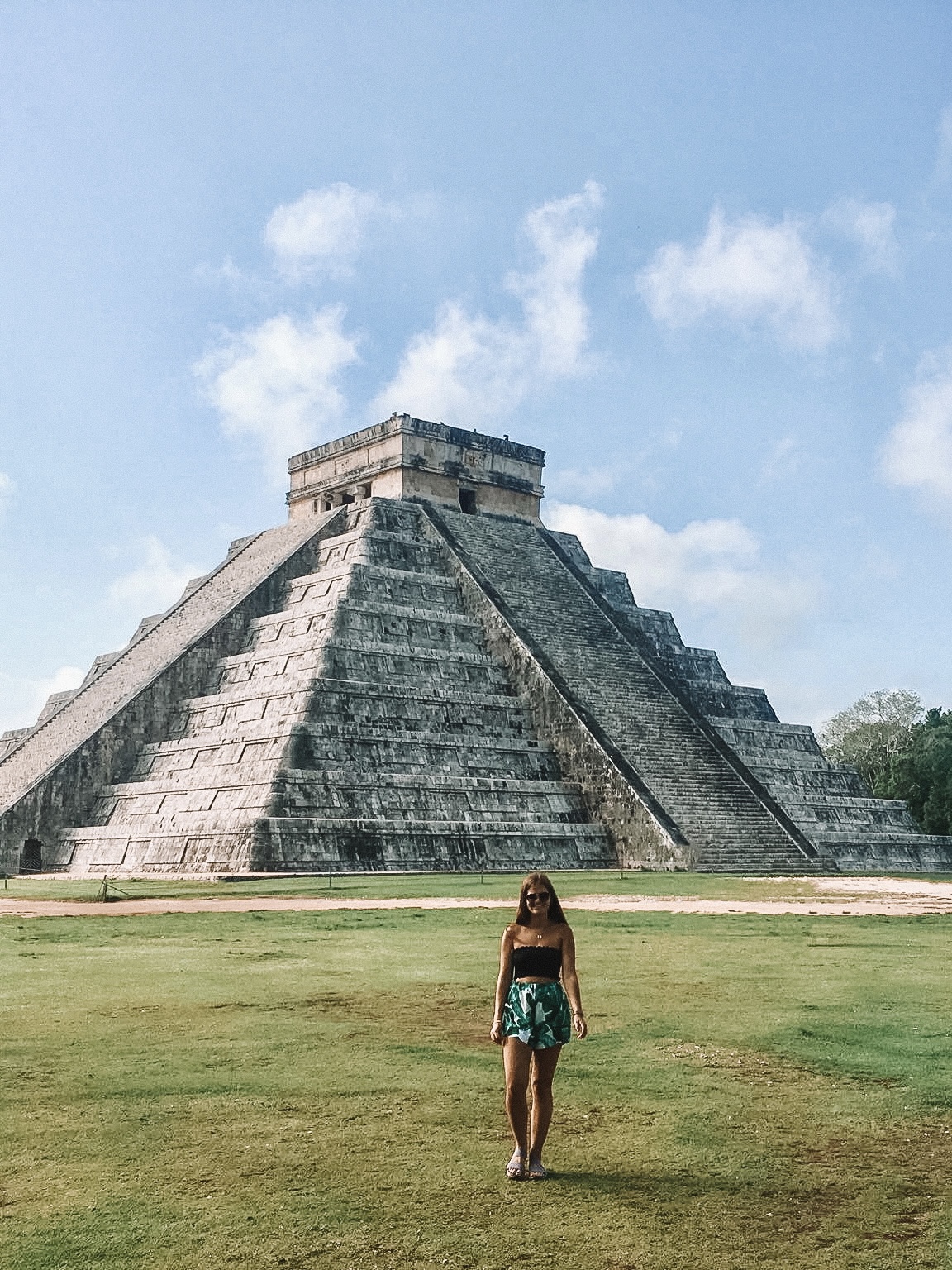 Niki stands in front of Chichen Itza pyramids, Quintana Roo, Mexico