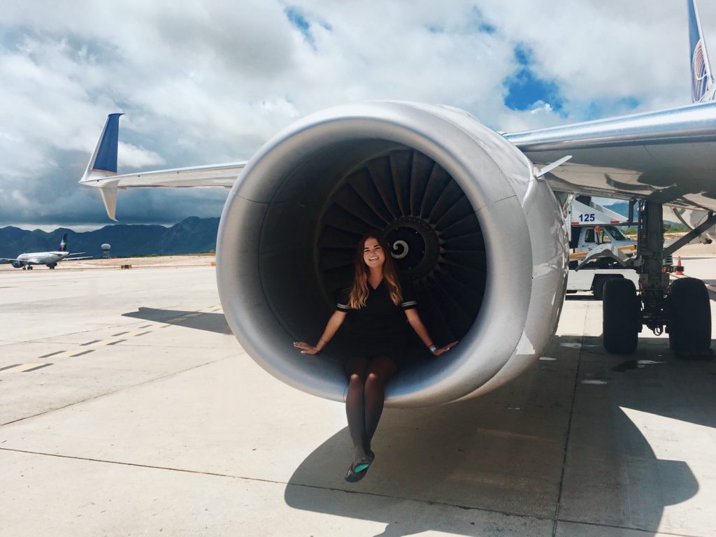 I quit my dream job as a flight attendant: Niki on a work trip to Cabo, Mexico. She is sitting inside an airplane engine.