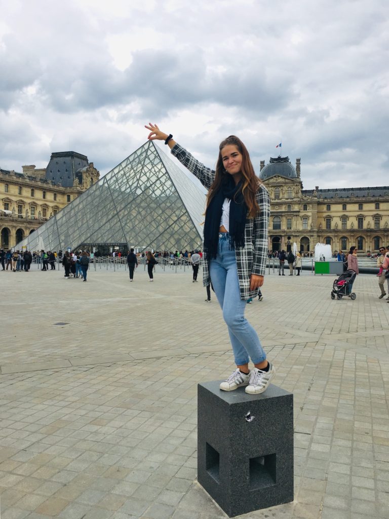 One day in Paris: Niki stands outside the Louvre Museum, Paris, France