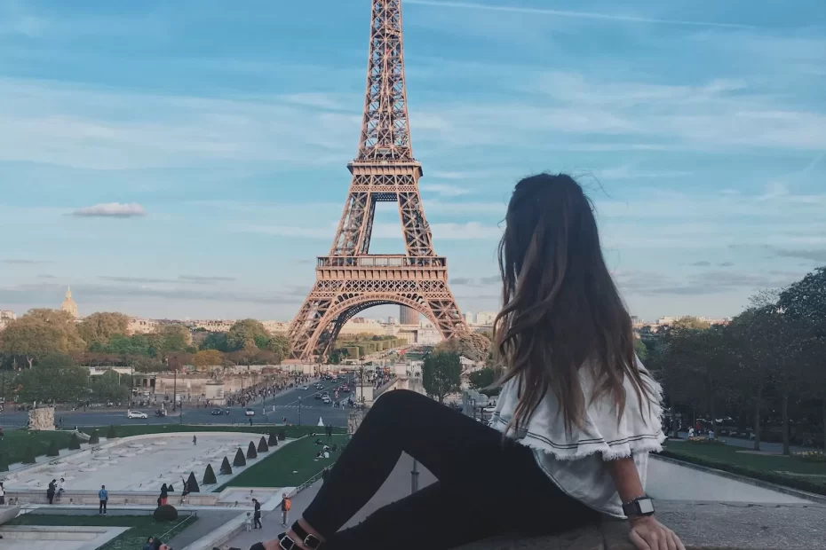Niki sits in front of the Eiffel Tower in Paris, France