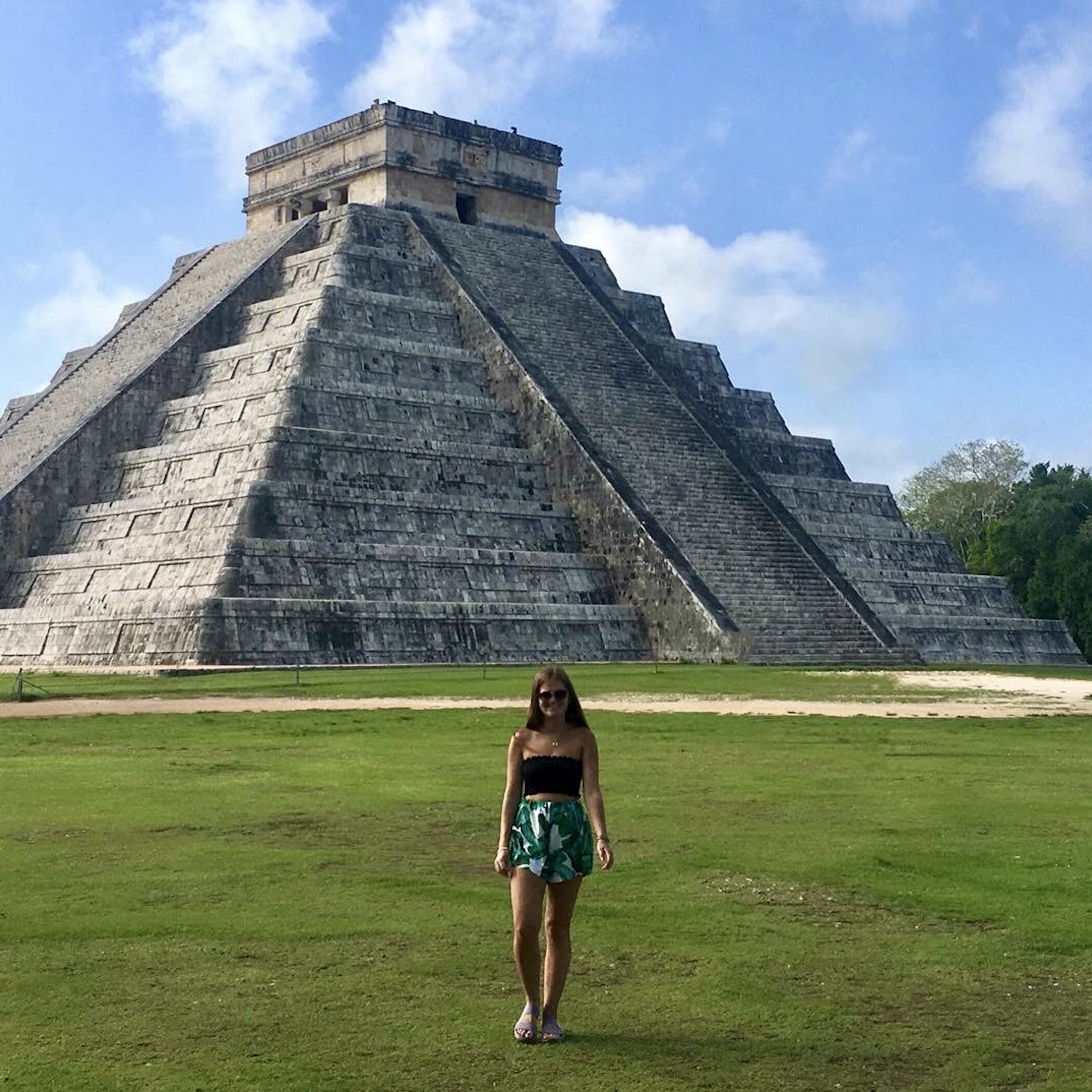 niki stands in front of chichén itzá archaeological site, yucatan peninsula, mexico (one of the new seven wonders of the world)