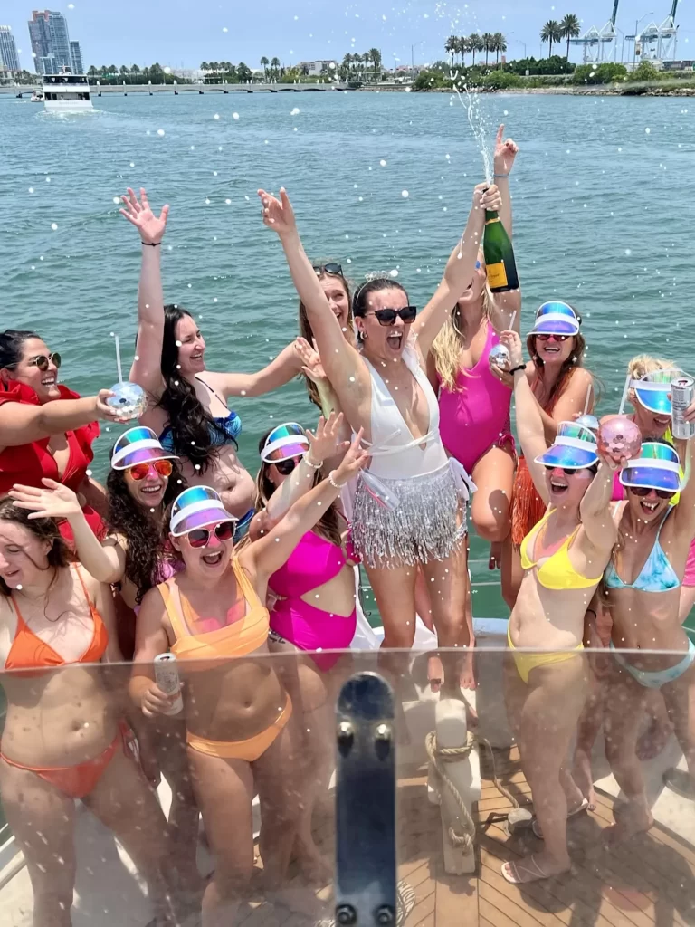 Miami girls trip: 11 girls in neon bikinis on a boat in Miami, Florida