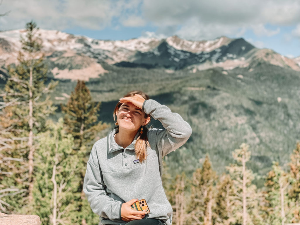 Rocky Mountain National Park itinerary: Niki sits in front of mountains, Colorado