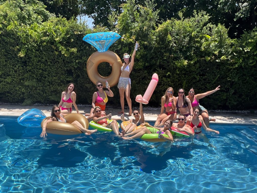 Miami girls trip: Girls pose in the pool during a bachelorette party in Miami, Florida