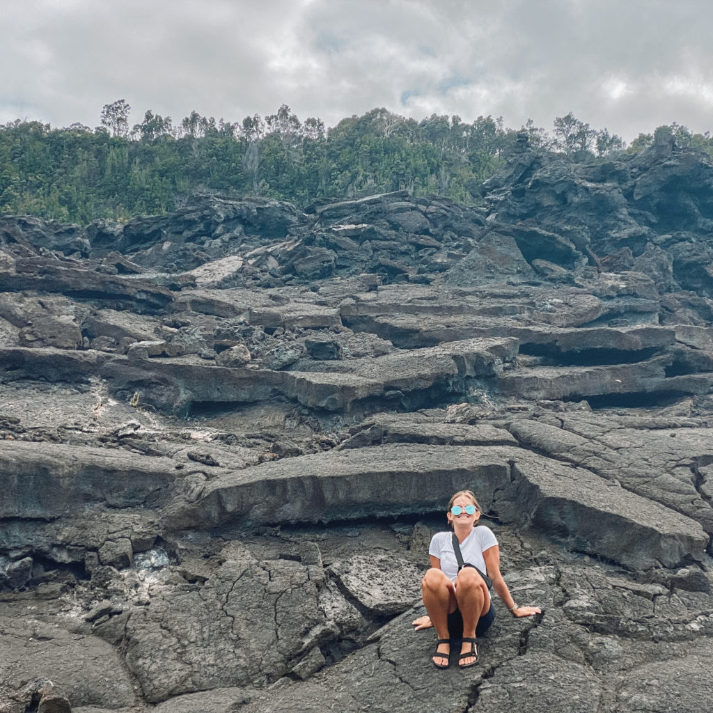 Niki sits on a pile of volcanic rock, Kilauea Iki Crater Trail, Big Island