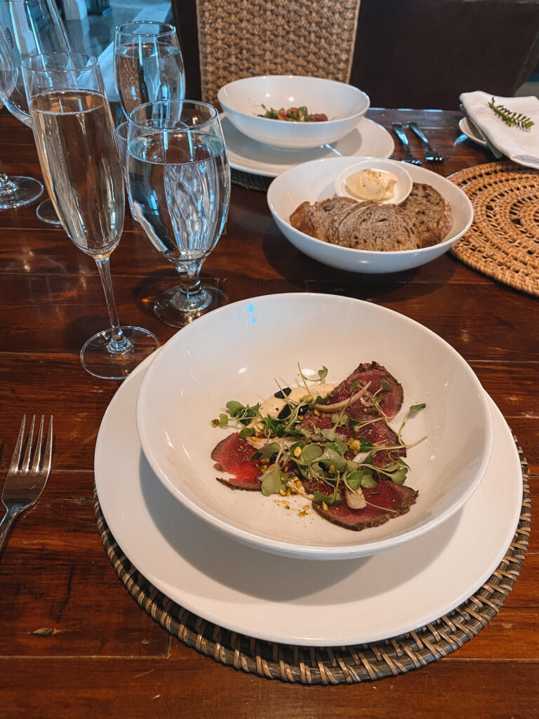 Glass of Prosecco and venison tartare, South Island, New Zealand