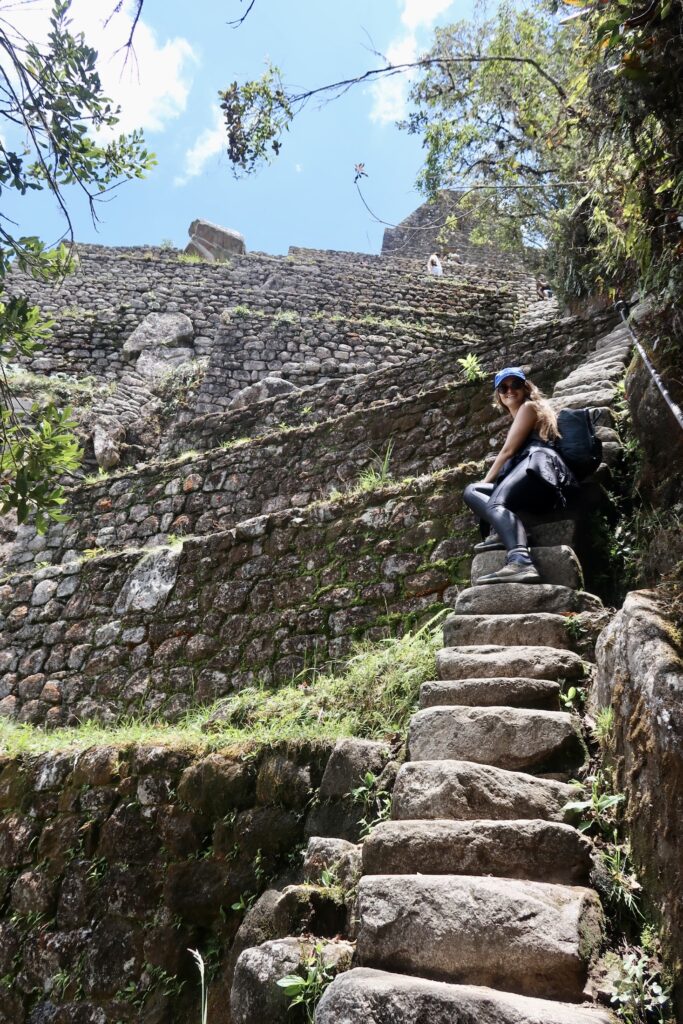 Niki sits on Stairs of Death while hiking Huayna Picchu, Peru