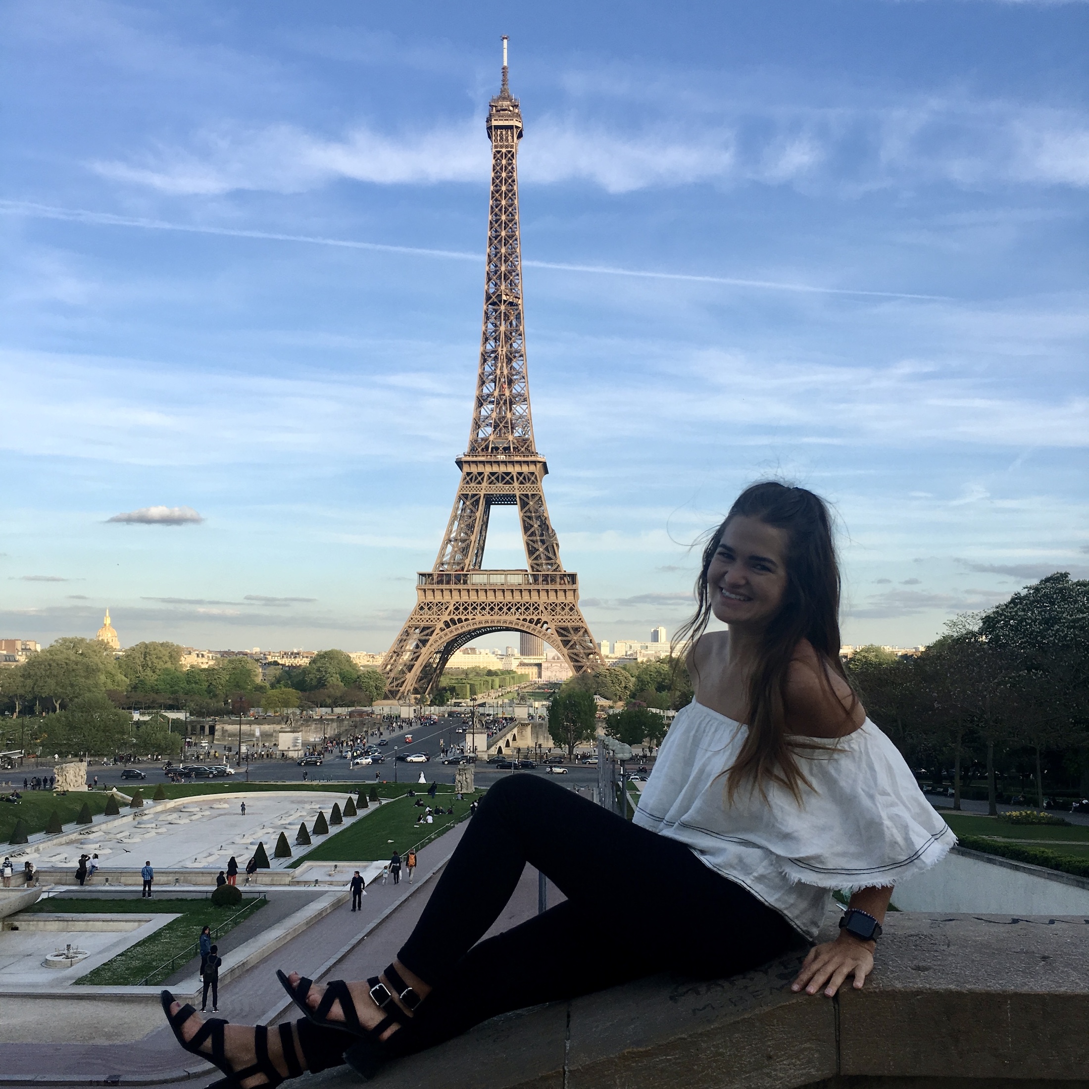 niki sitting in front of the eiffel tower, paris, france