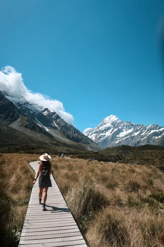Niki walks along boardwalk on the Hooker Valley Track, Aoraki Mount Cook National Park, New Zealand