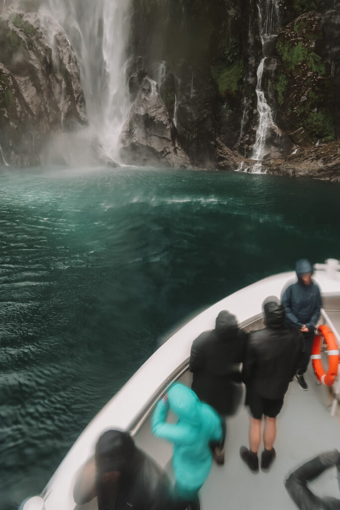 Milford Sound vs Doubtful Sound: Waterfall in Fiordland National Park, New Zealand