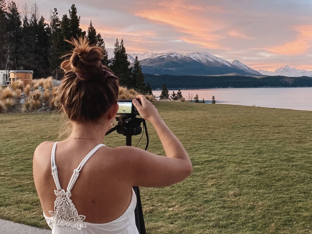 Is eDreams Prime worth it? Niki taking a picture of the sunset at Mt Cook Lakeside Retreat, Lake Pukaki, Canterbury, South Island New Zealand