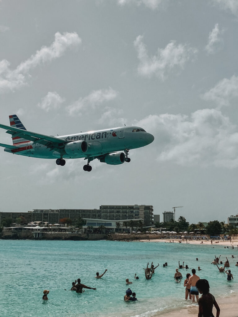 Flying captions: American Airlines airplane landing in St Maarten (SXM) Airport